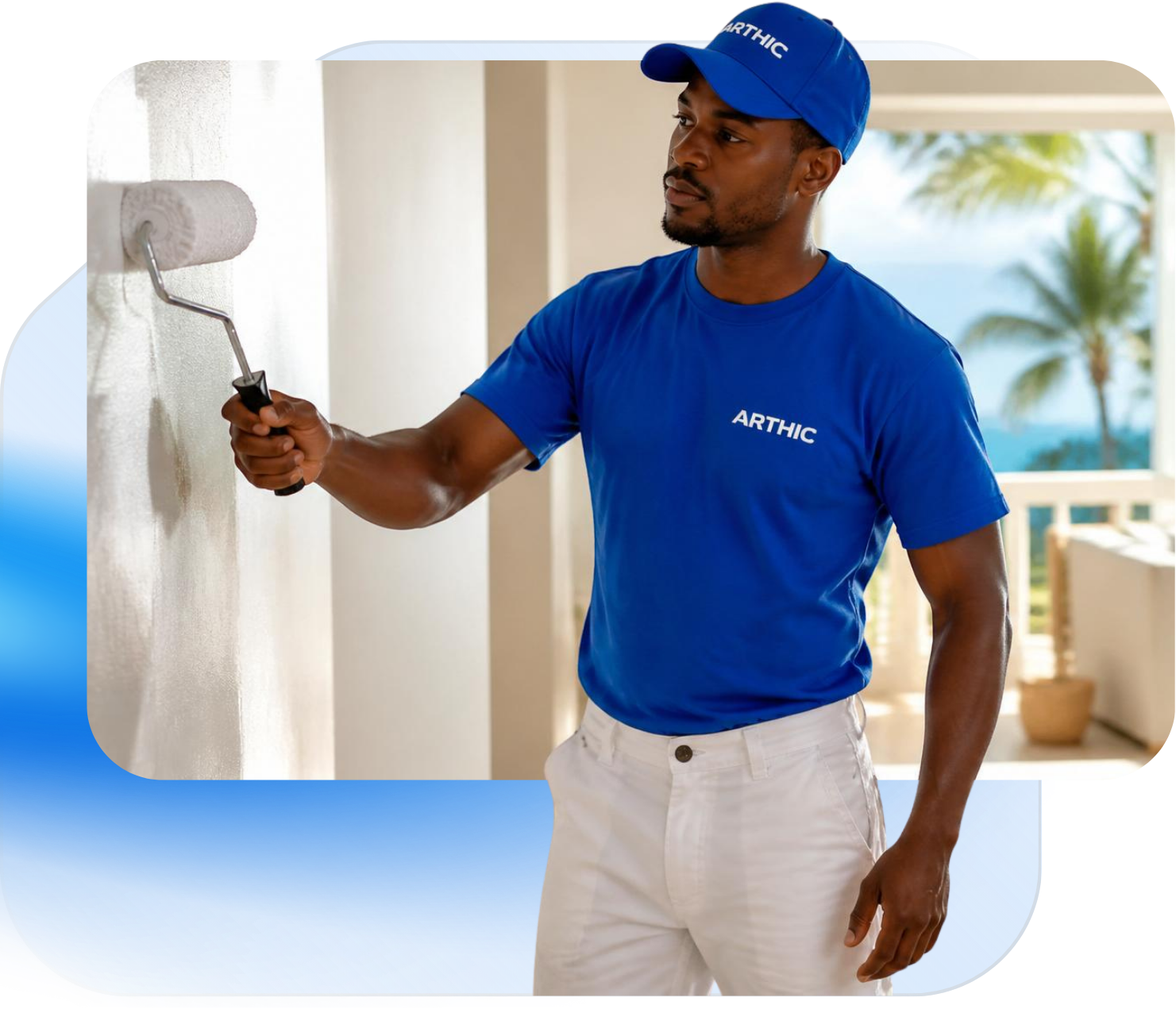 Arthic contractor in a branded blue shirt and cap rolling fresh paint onto an interior wall